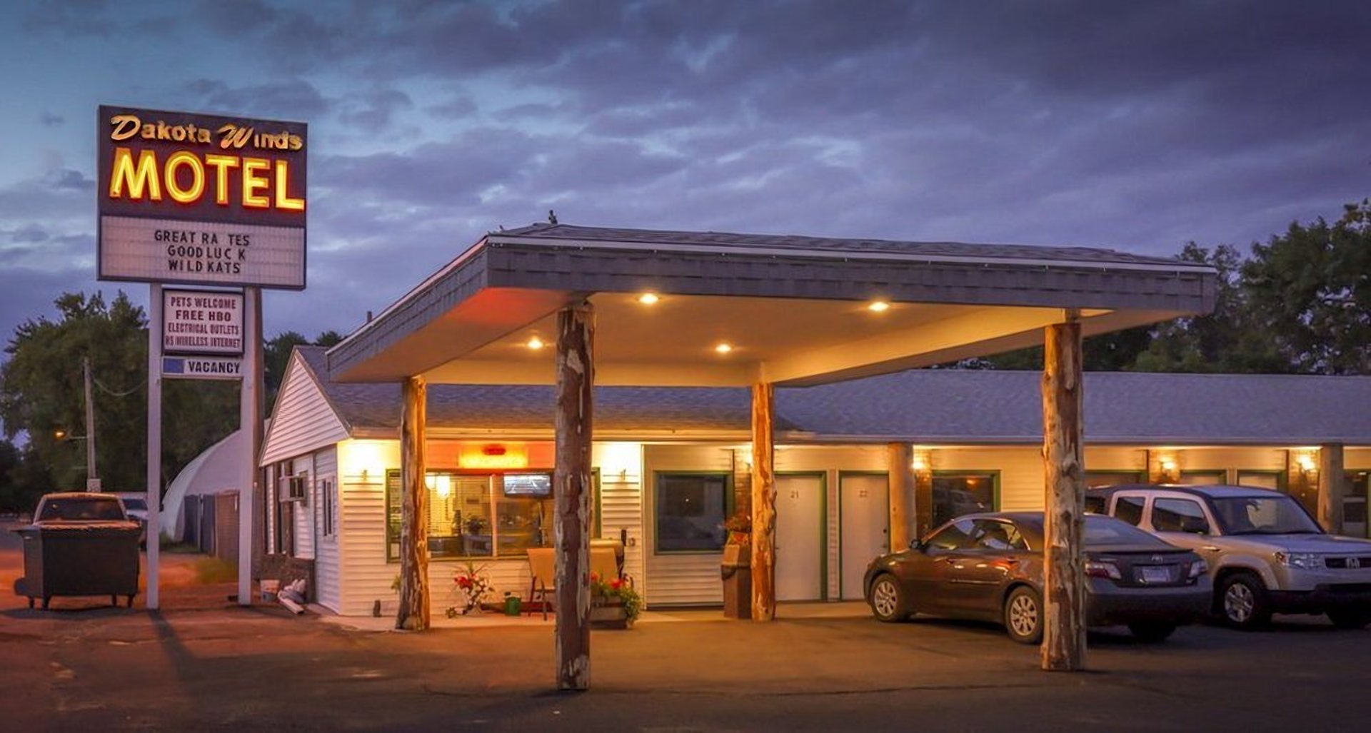 Dakota Winds Motel at dusk with its lit roadside MOTEL sign on Main Street in Kimball, South Dakota