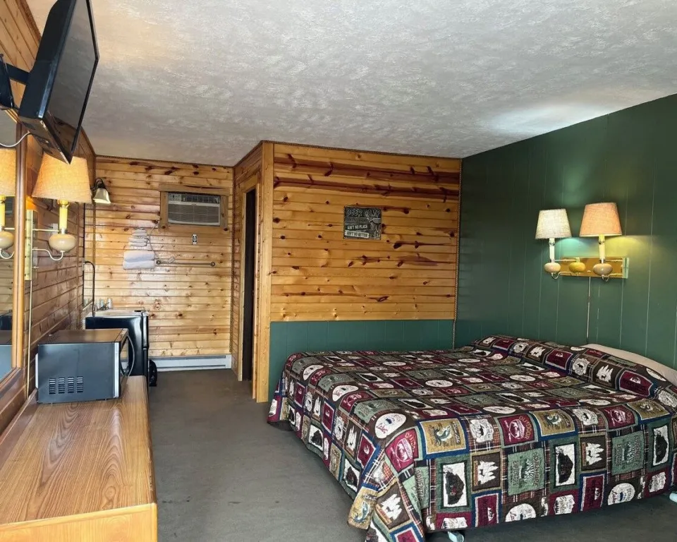 Single King Room with a king bed, pine walls, flat-screen TV, mini fridge and microwave