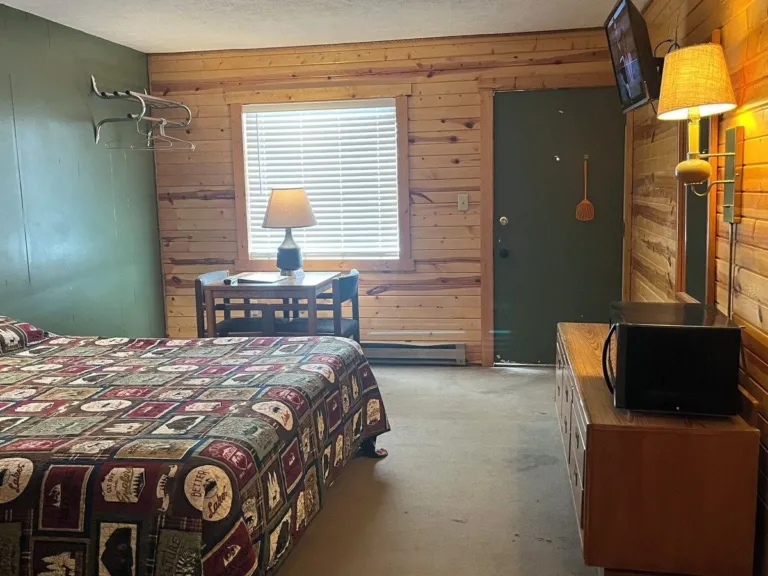 Single King Room seating area with a table, two chairs and a window